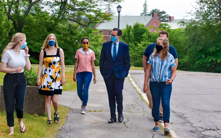 Dannel Malloy walking with students (all are masked)