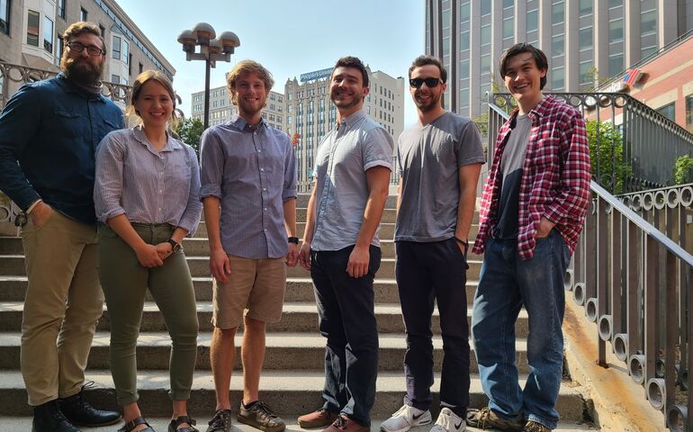 Kinotek team in downtown Portland, standing on steps near Monument Square.