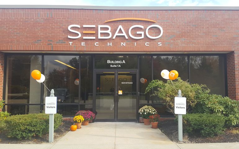Exterior of Sebago Technics office in South Portland showing sign above door.