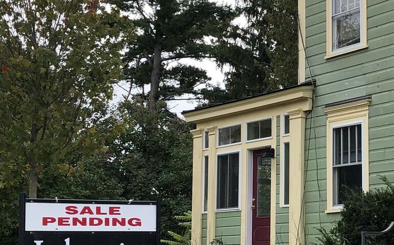 a house with a sale pending sign in front