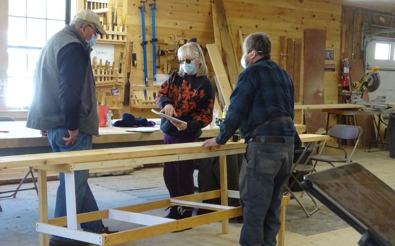 wood working workshop people wearing masks