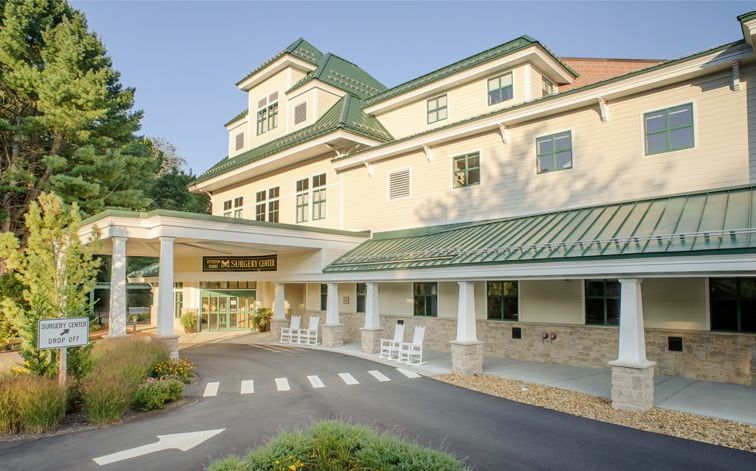 entrance portico to large yellow three-story building