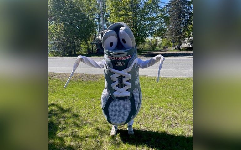 Photo of a smiling sneaker mascot 
