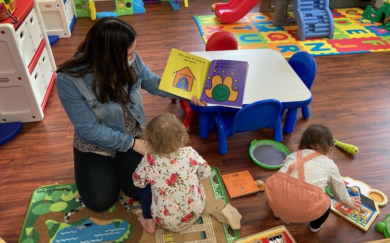 Woman with small child in child care center 