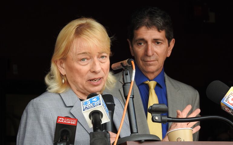 Janet Mills with Eric Cioppa in front of TV microphones