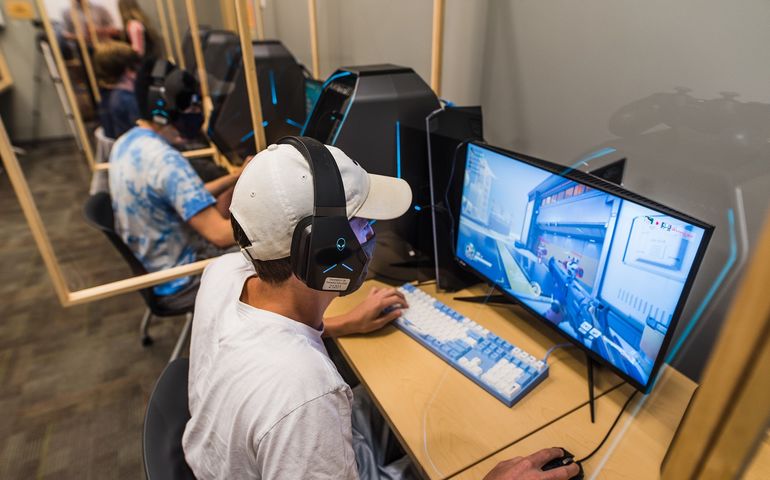 Persona at computer screen looking at esports or gaming