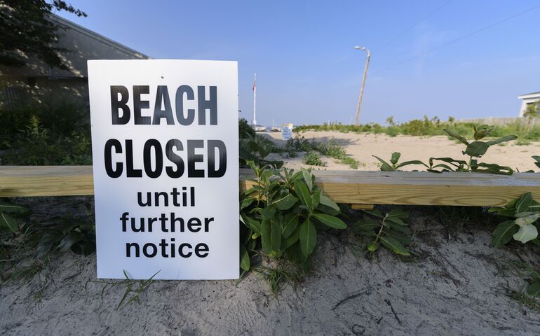 Willard beach with sign saying "Beach Closed Until Further Notice."