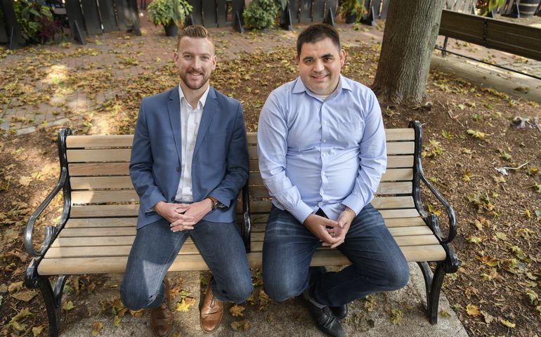 MedRhythms co-founders sitting on a bench with leaves on the ground 