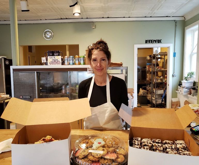 person with boxes of pastries