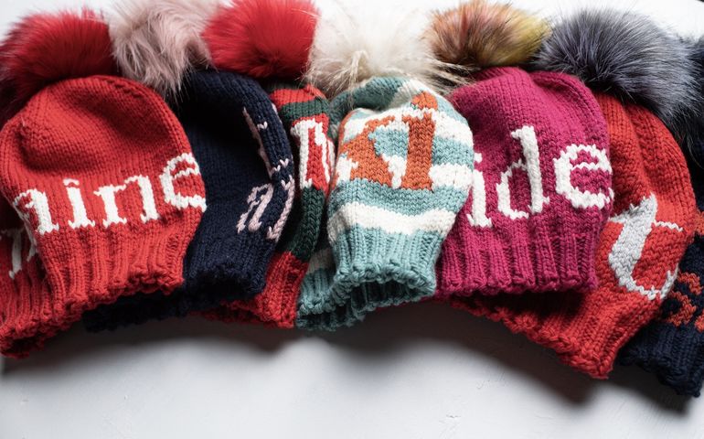 Knitted hats with words on them 