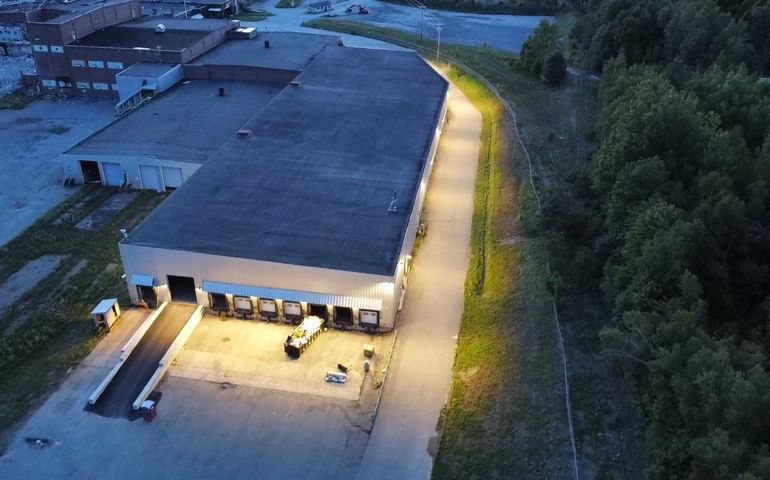 aerial of factory with trucks and lights