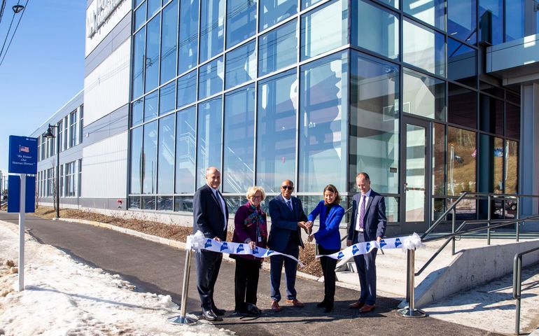 5 people cutting ribbon