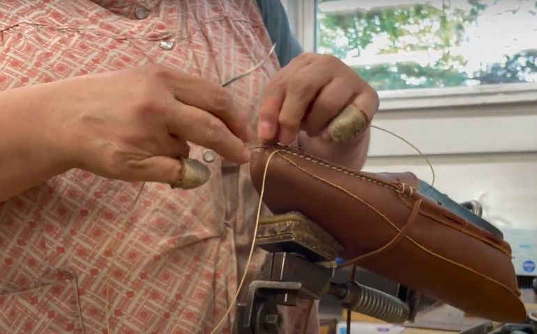 close-up of woman stitching a moccasin