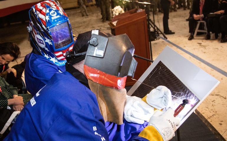 2 people in welding masks