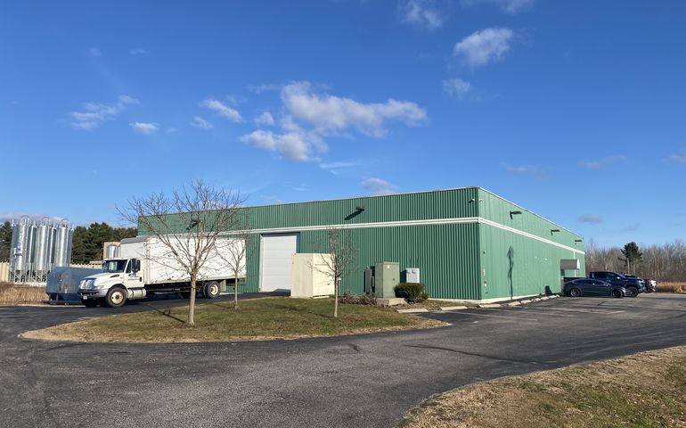 green metal building and truck