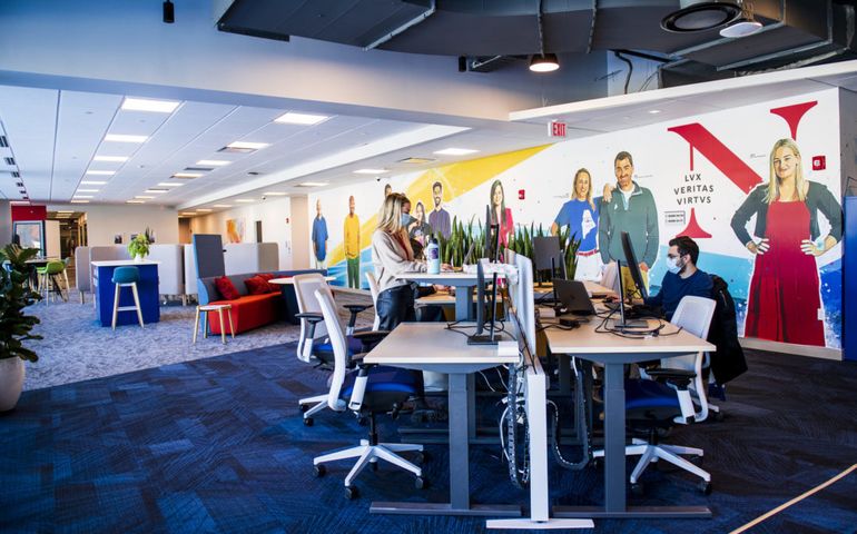 Roux Institute campus interior showing people at computer screens 