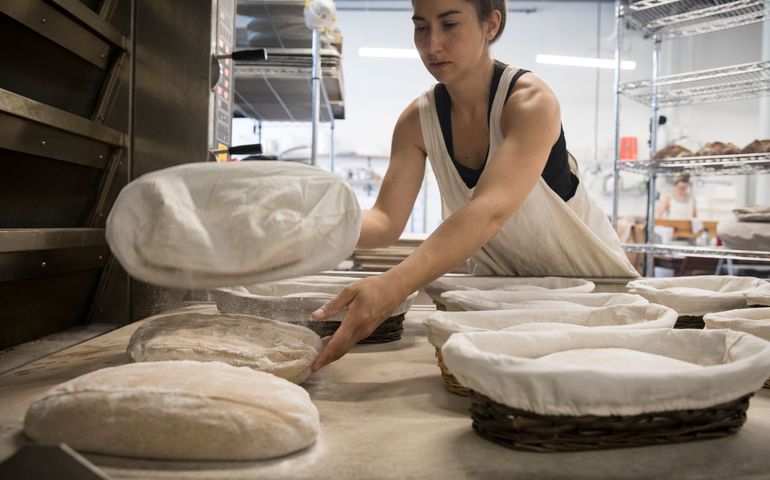 person with bread loaves