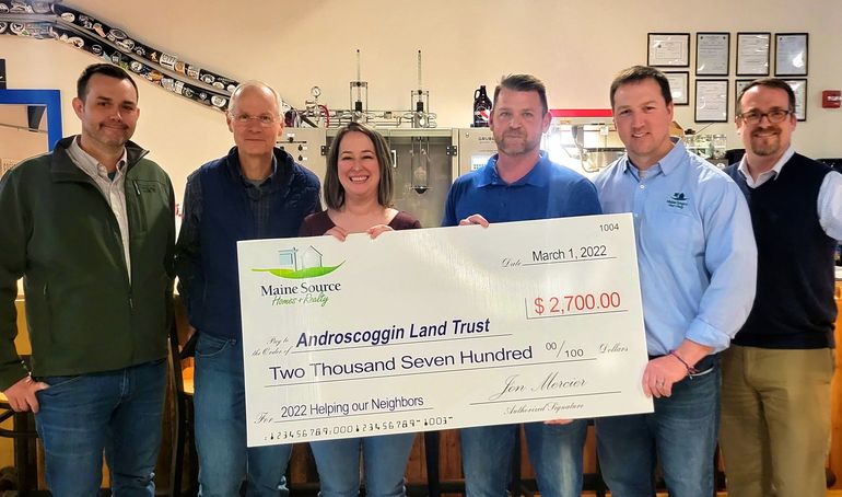 6 people with big check
