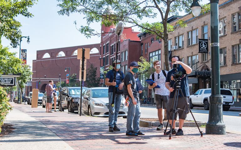 film crew on sidewalk