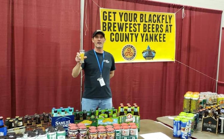 man holding beer at beer display