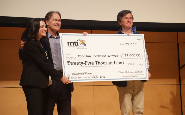 People holding an oversized $25,000 check 