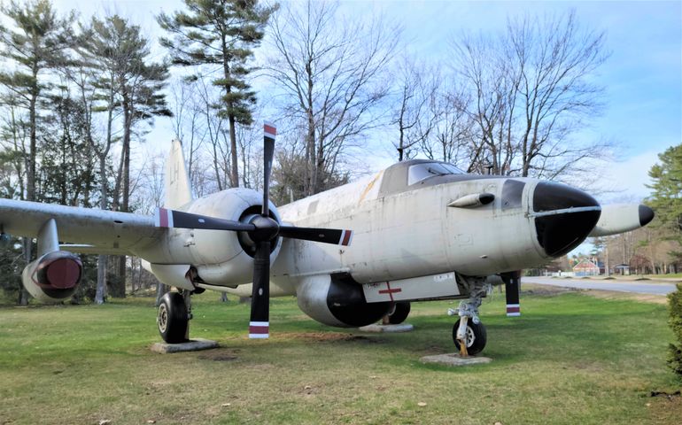 military airplane parked on grass