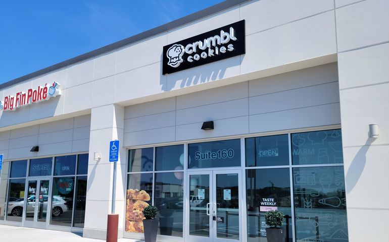 storefront with windows and "crumbl" sign