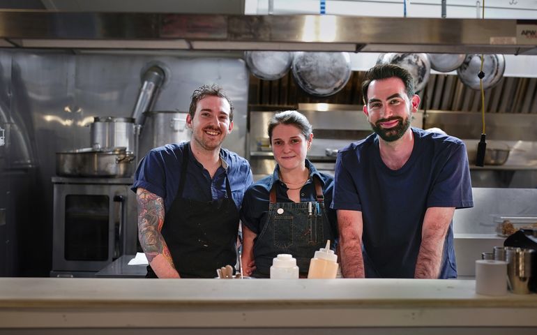 3 people in kitchen smiling