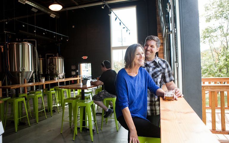 2 people smiling at bar