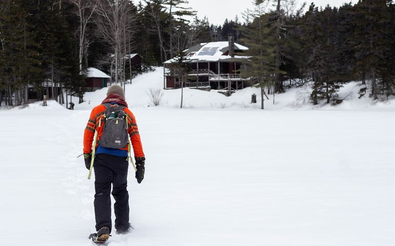 person on snow with lodge