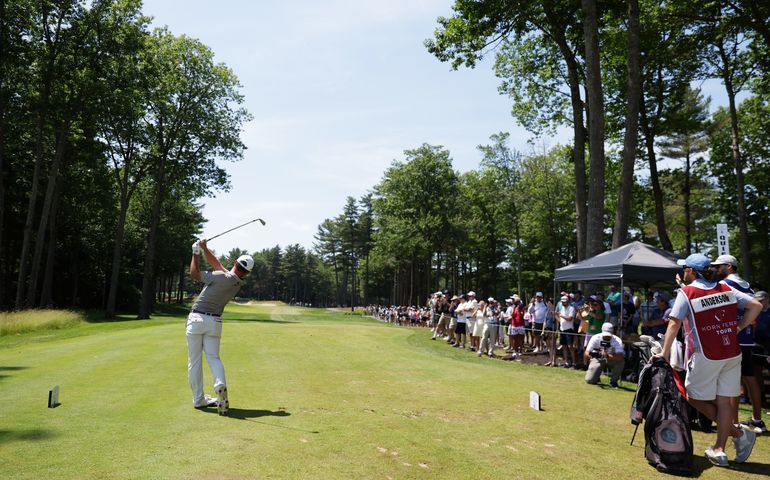 spectators and golfer on green