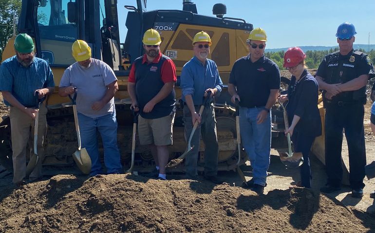 people with shovels and dirt