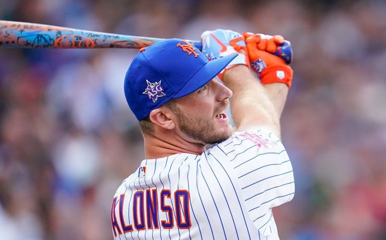 Baseball player Pete Alonso swinging a bat. 