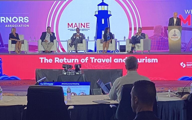 Panelists seated on stage 