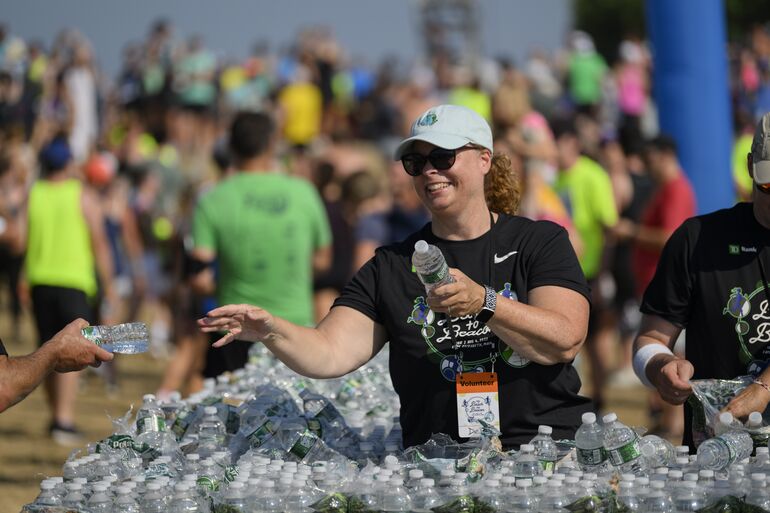 Volunteer with water bottles.