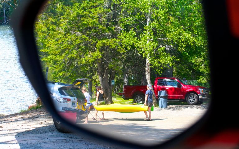 reflection of 2 people and kayak