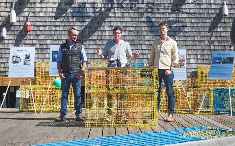 3 people on wharf with lobster traps