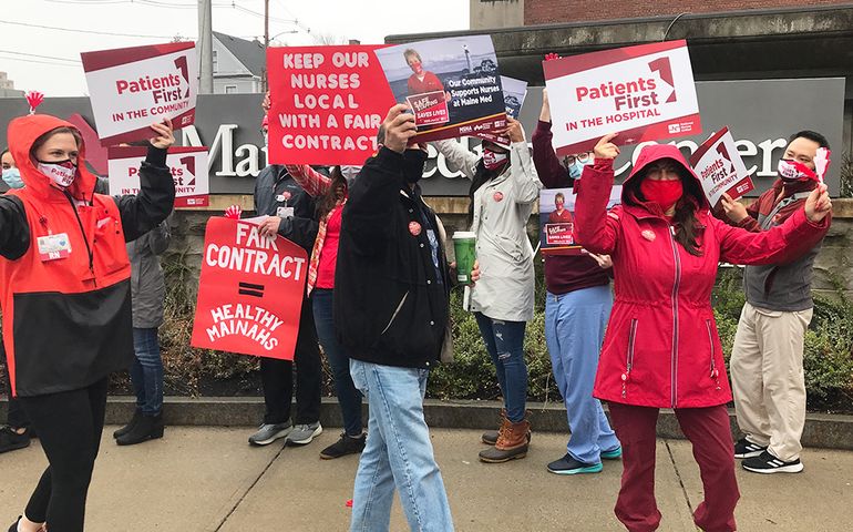 Nurses protesting with signs 