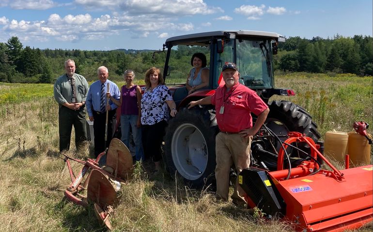 people with tractor in field