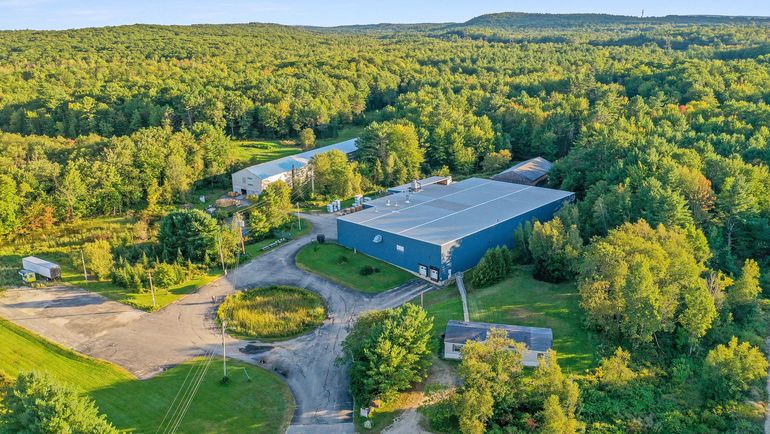 aerial of metal building and woods