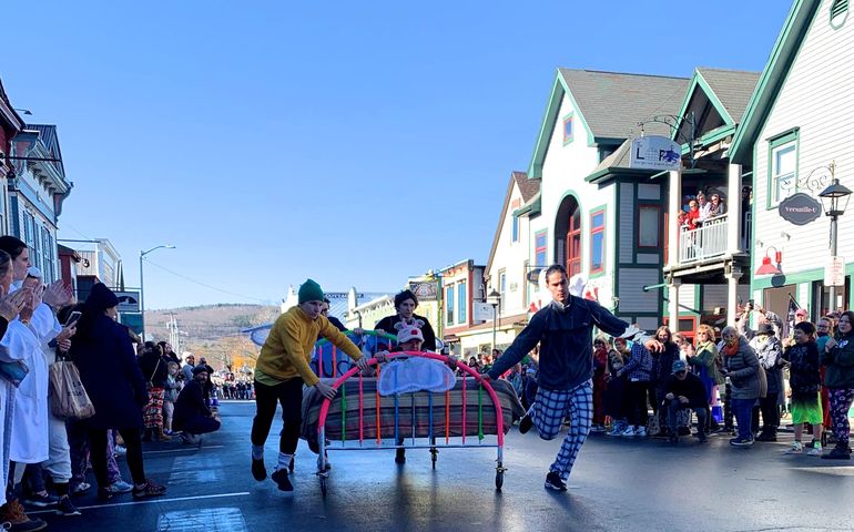 bed on street and people