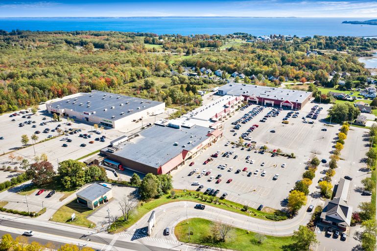 aerial of buildings, parking lot, water