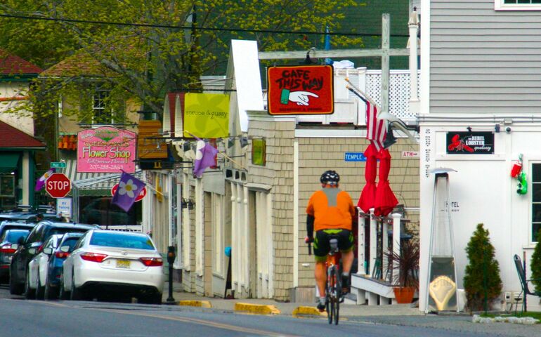shops signs cars bicyclist