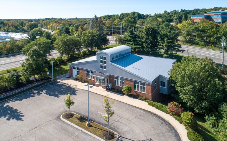 building with hump and parking lot