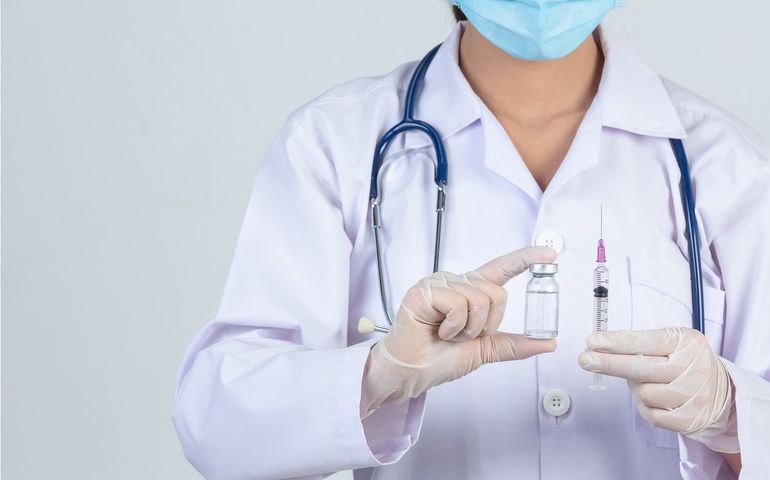 medical professional holding syringe