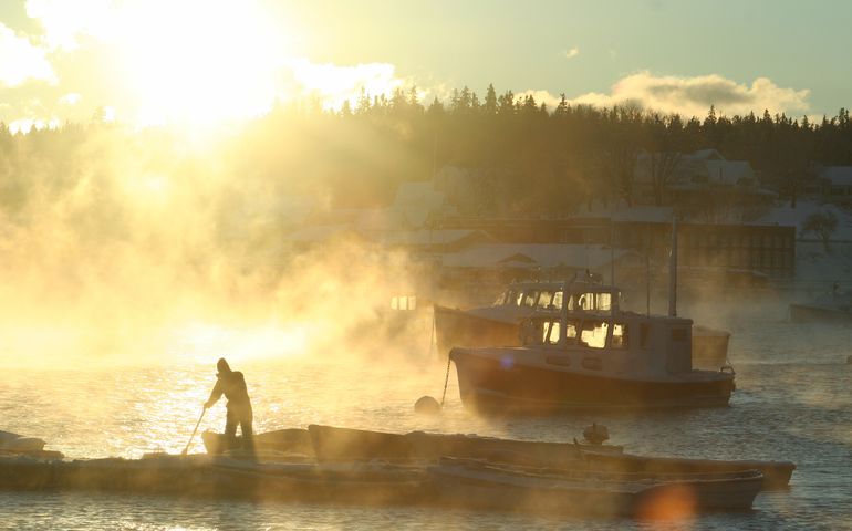 sunrise on person boat harbor