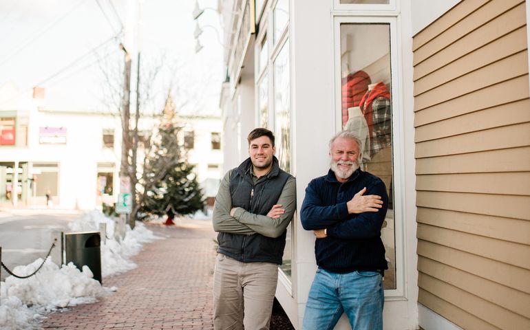 two people by building with arms crossed