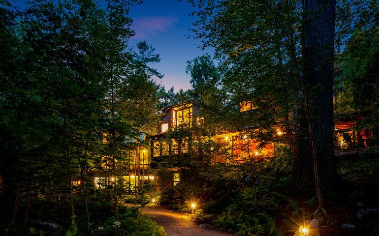 big house at night with lights on