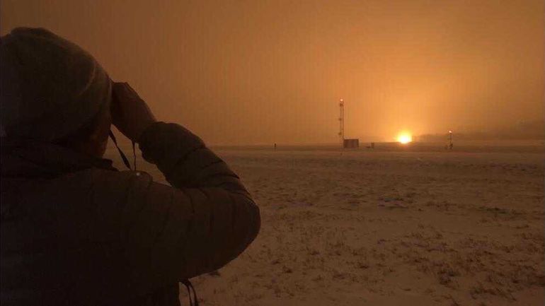 orange sky, rocket blast, person watching