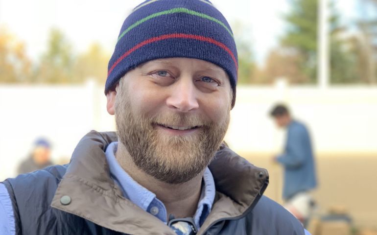 person in hat and vest